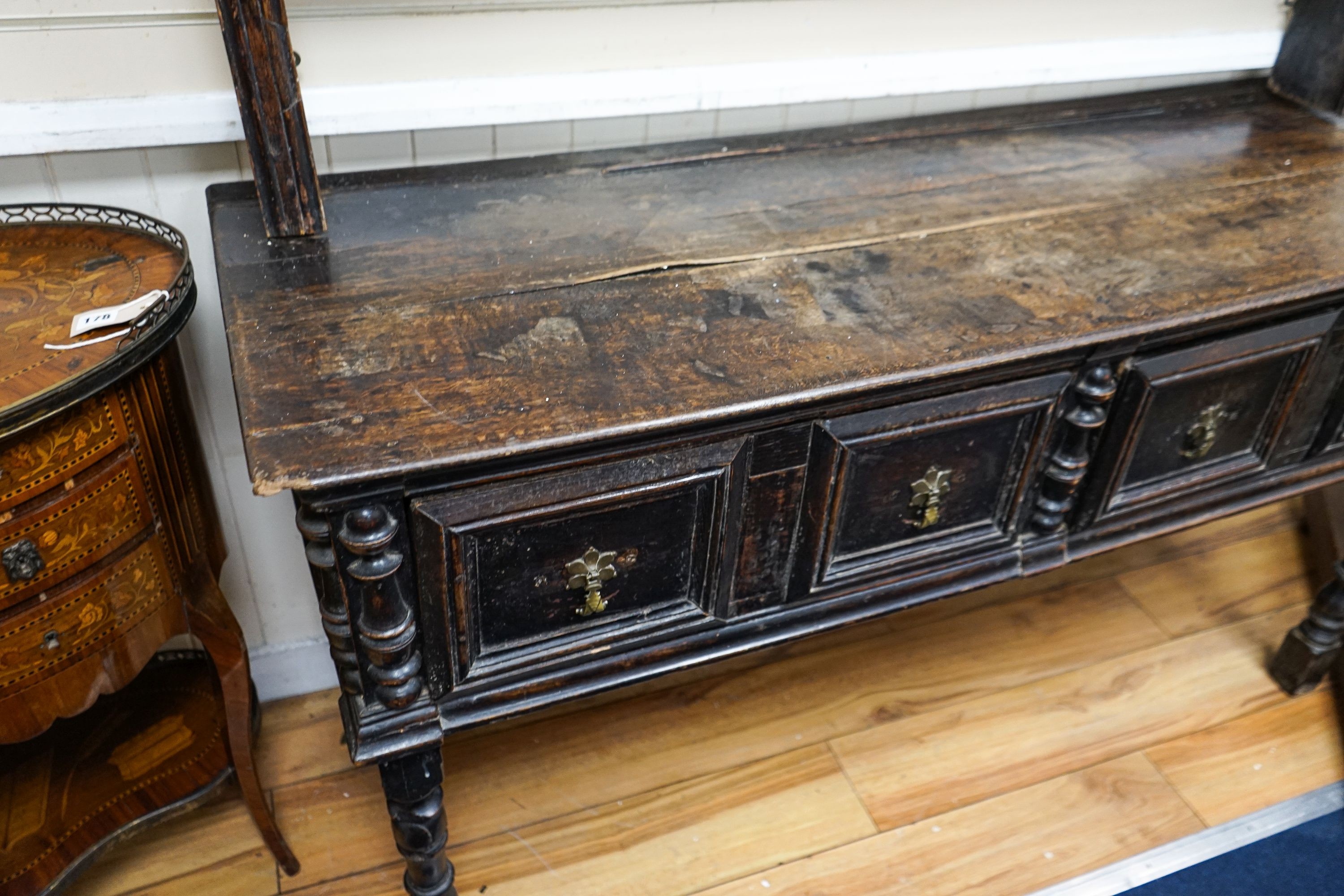 An 18th century and later oak dresser, the base fitted two drawers on turned supports, with two-tier plate rack over, width 147cm, depth 50cm, height 181cm